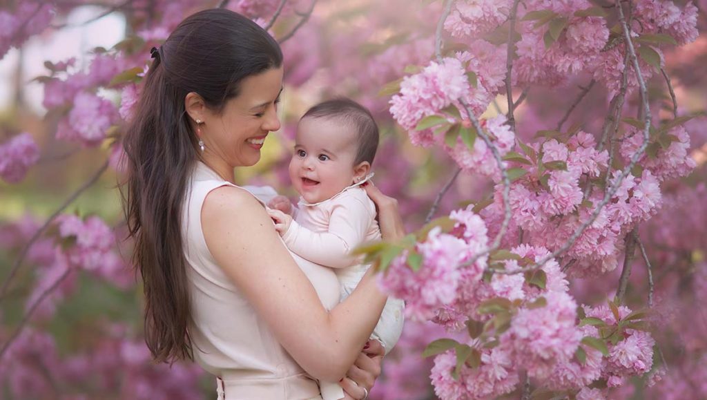 Spring cherry blossoms family photo shoot Photo shoot of a mother and her baby girl amidst blooming cherry blossom trees