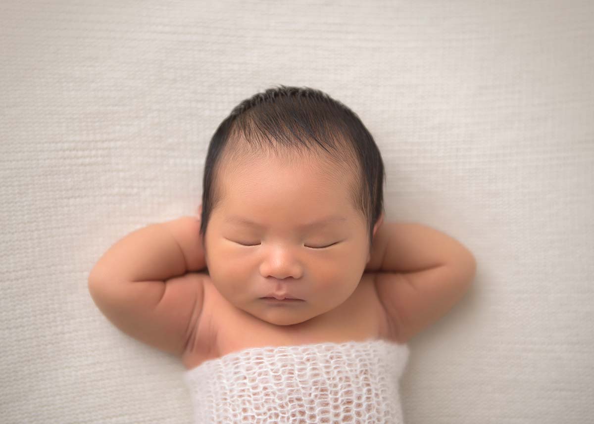 Baby sleeping on a blanket during a newborn photo shoot in Westchester County, NY.