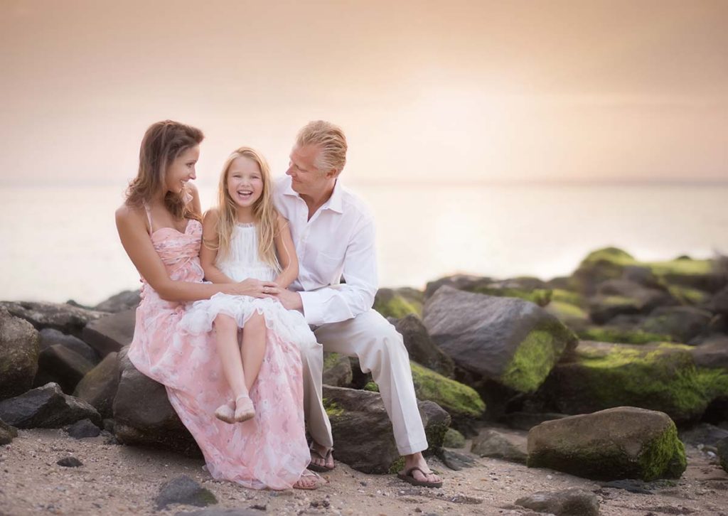 A beautiful beach family photo of a mother, father and their daughter taken in Greenwich CT