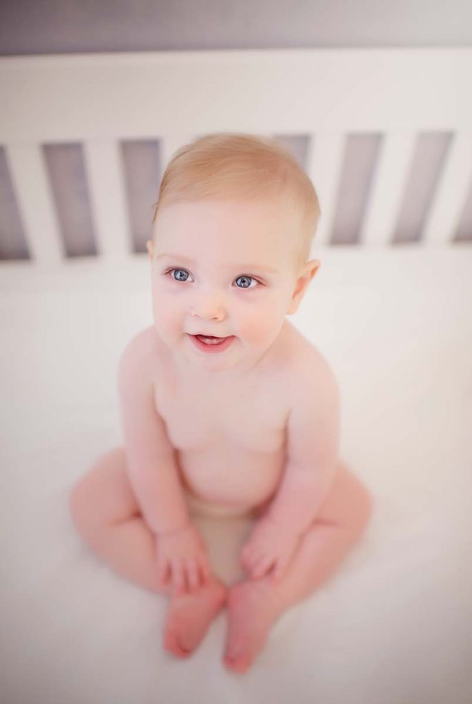 big blue eyes baby nursery Portrait of a child in her crib as captured by a baby photographer