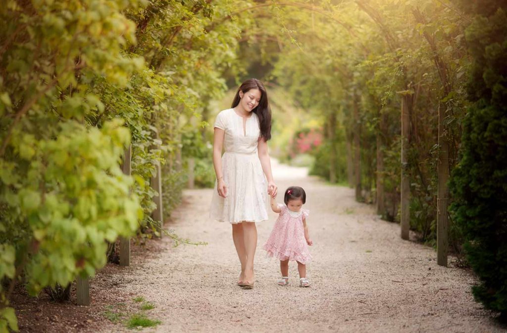 Mother and her baby walking through a bridle path in a park in Westchester county New York