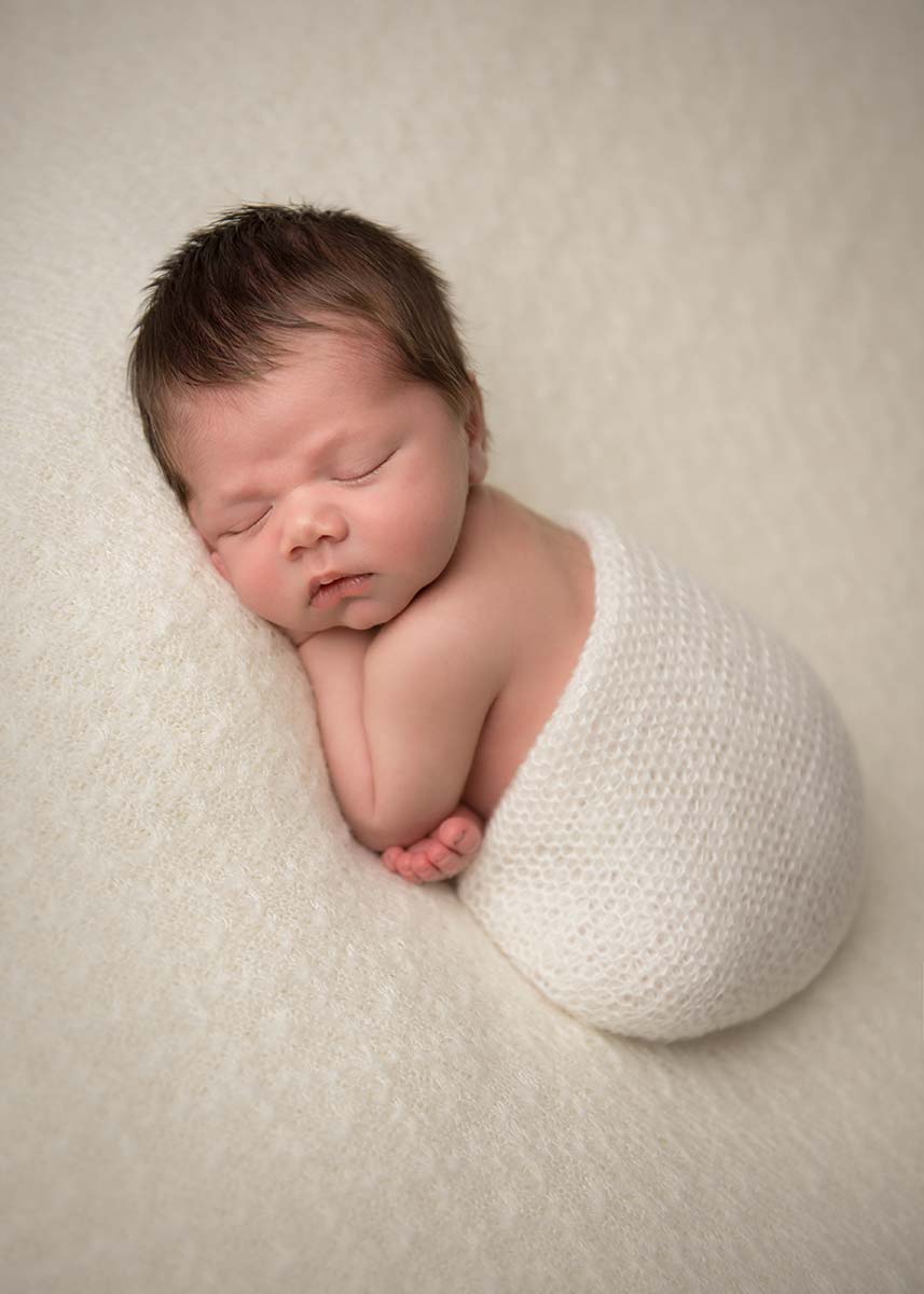 A baby sleeping in a photography studio in Denver, CO.