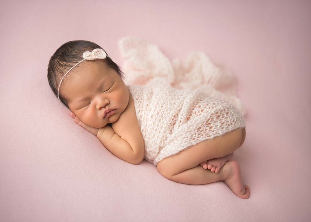 Stunning photo of a newborn in a knit wrap