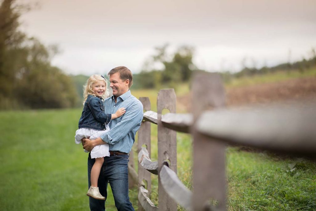 A farm in Danbury CT is the setting for this beautiful family photograph between a father and his young daughter.