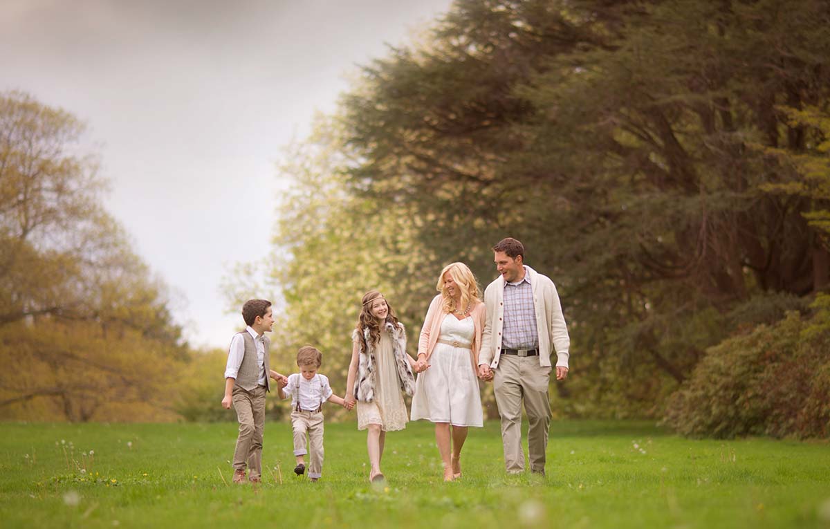 Happy family walking in a park during their photoshoot in Denver