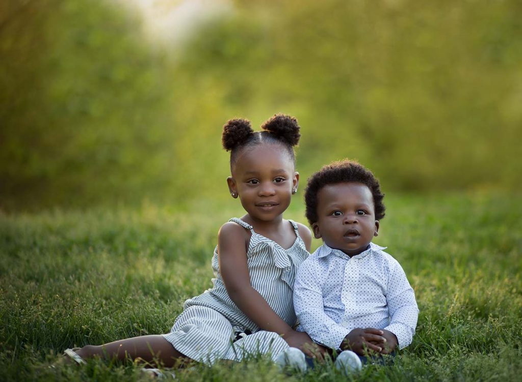Westchester siblings sitting together Two baby siblings sitting together in this beautiful family photo