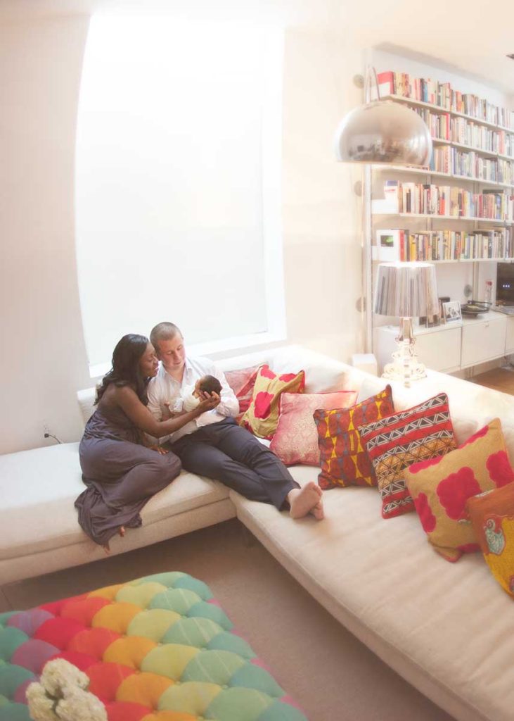 family newborn lifestyle Modern apartment with a mother and father holding their baby boy for a newborn photographer