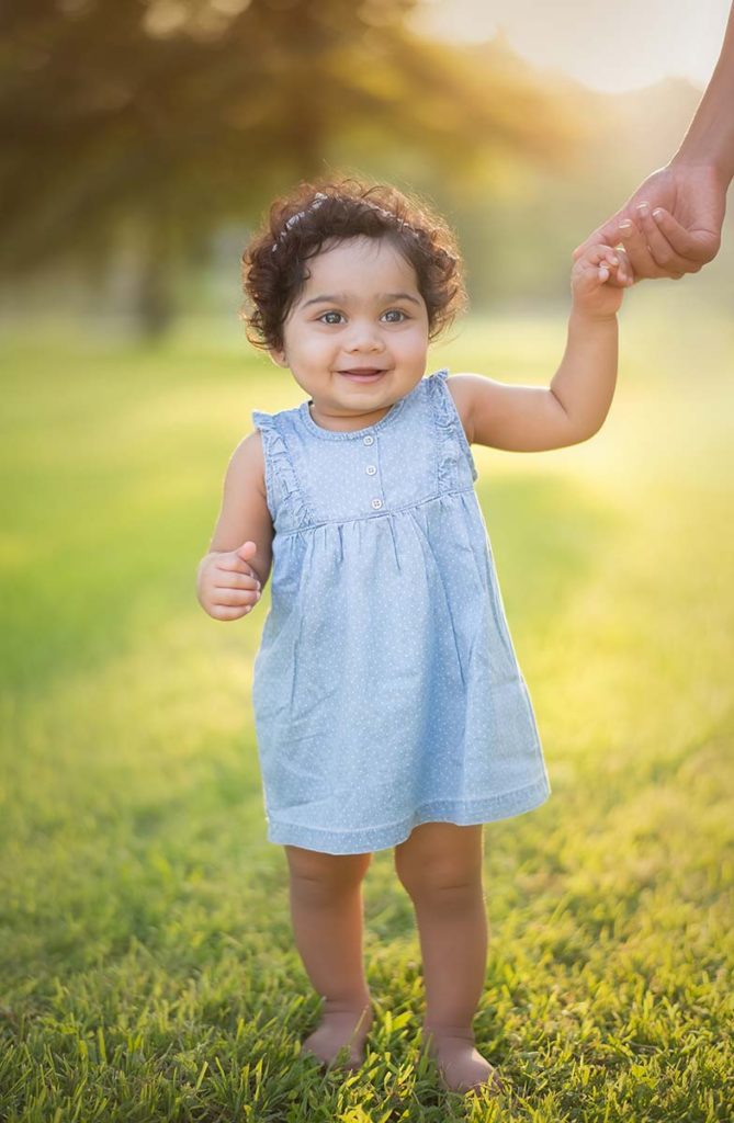girl holding mother hand Sweet girl smiling and holding her mother's hand