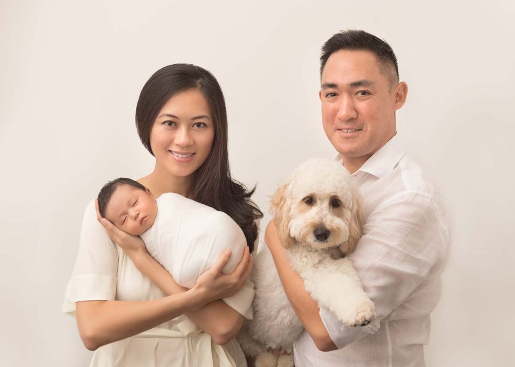 This Greenwich CT family posing for their first photo with their newborn baby