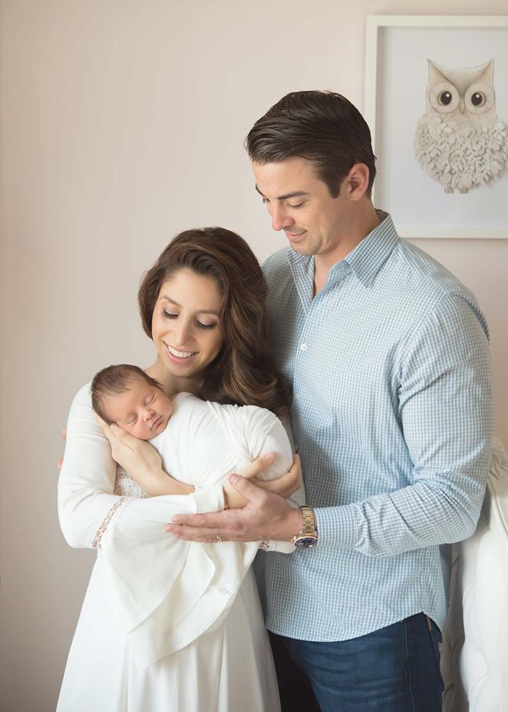 happy mom baby Father holding his newborn baby