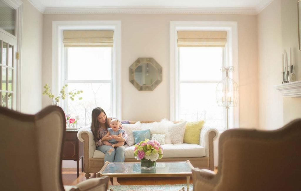 modern living room mother cuddles baby Beautiful Westchester home is the setting for this photograph