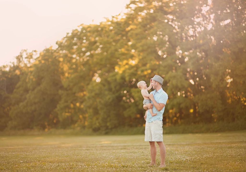 natural lifestyle family photographer Father holding his son during sunset