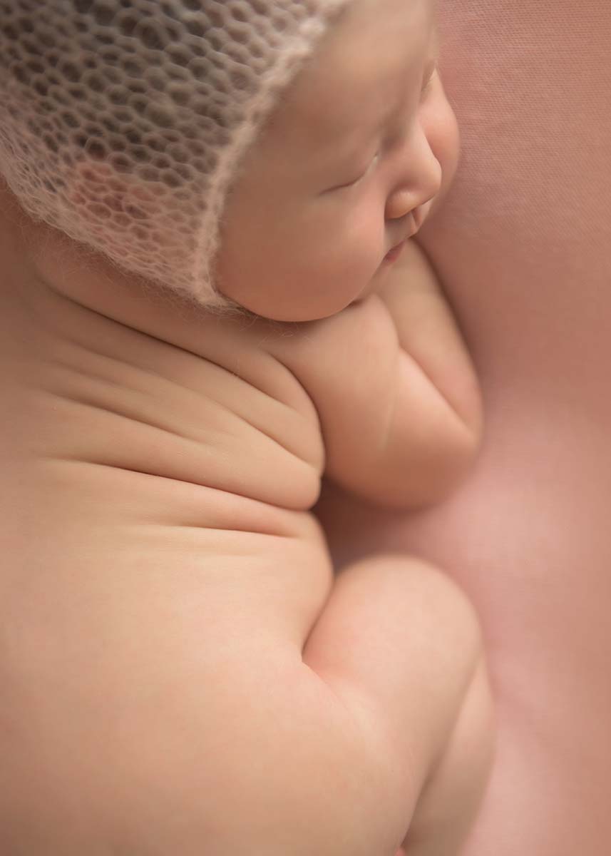 Chubby folds on a sleeping newborn draw the eye of a skilled baby photographer