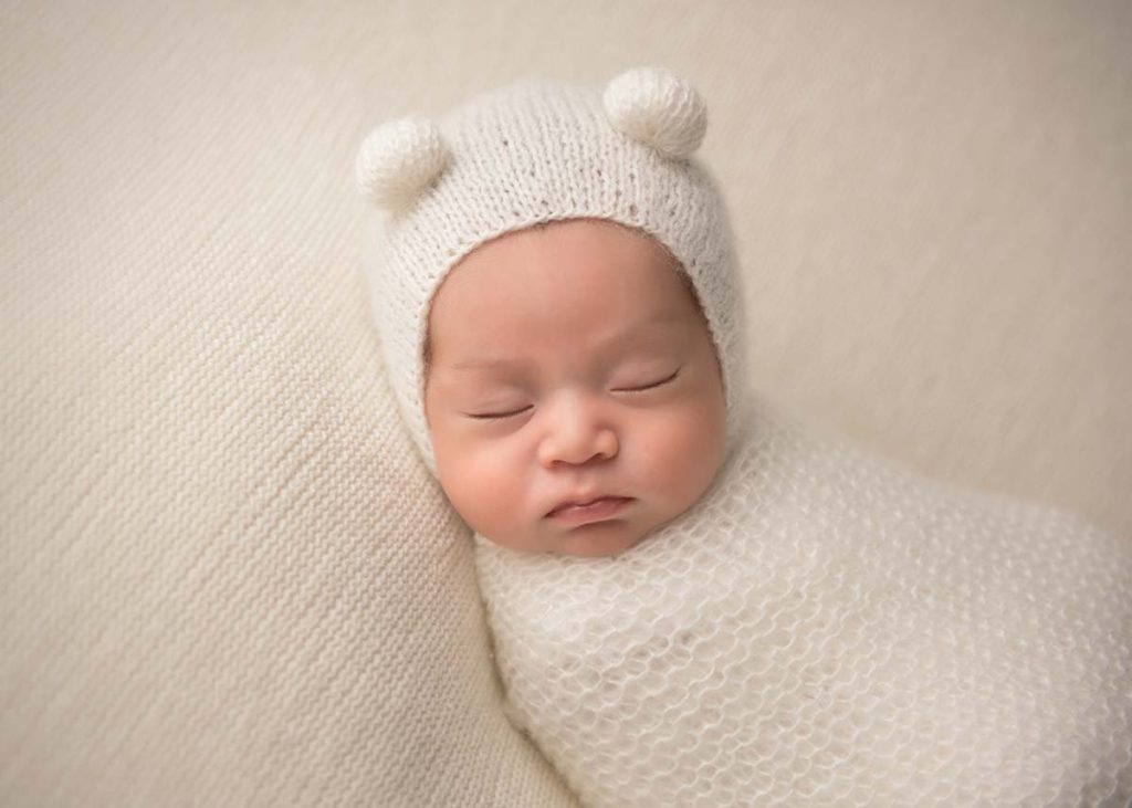 Teddy bear hat worn by a sleeping newborn at a photo studio in Westchester County NY