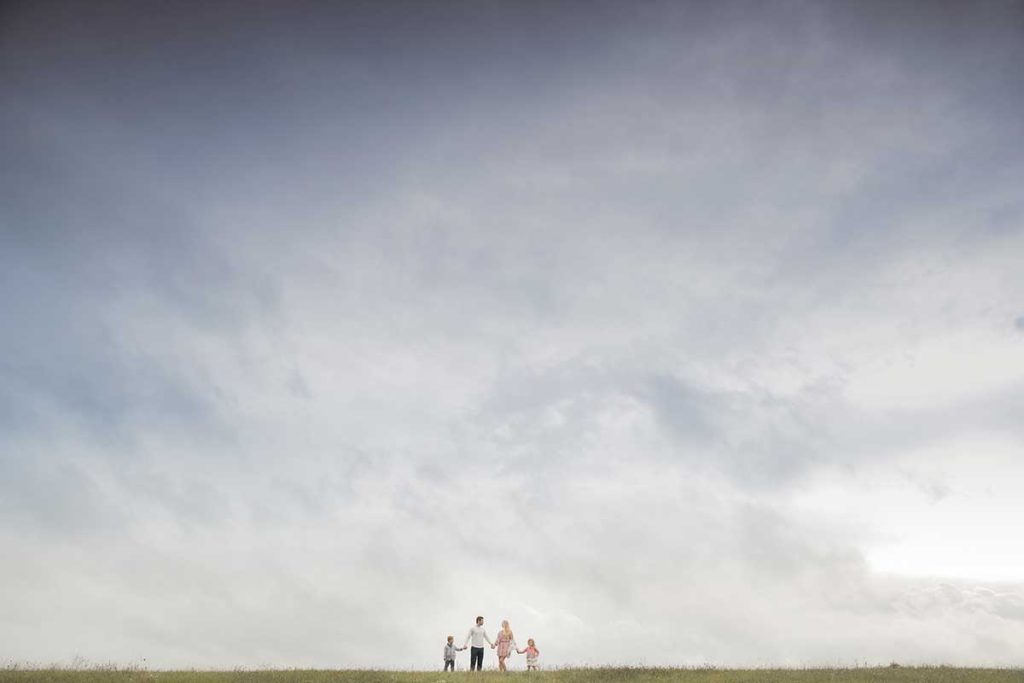 sky family dramatic Dramatic family photoshoot with dark sky and clouds