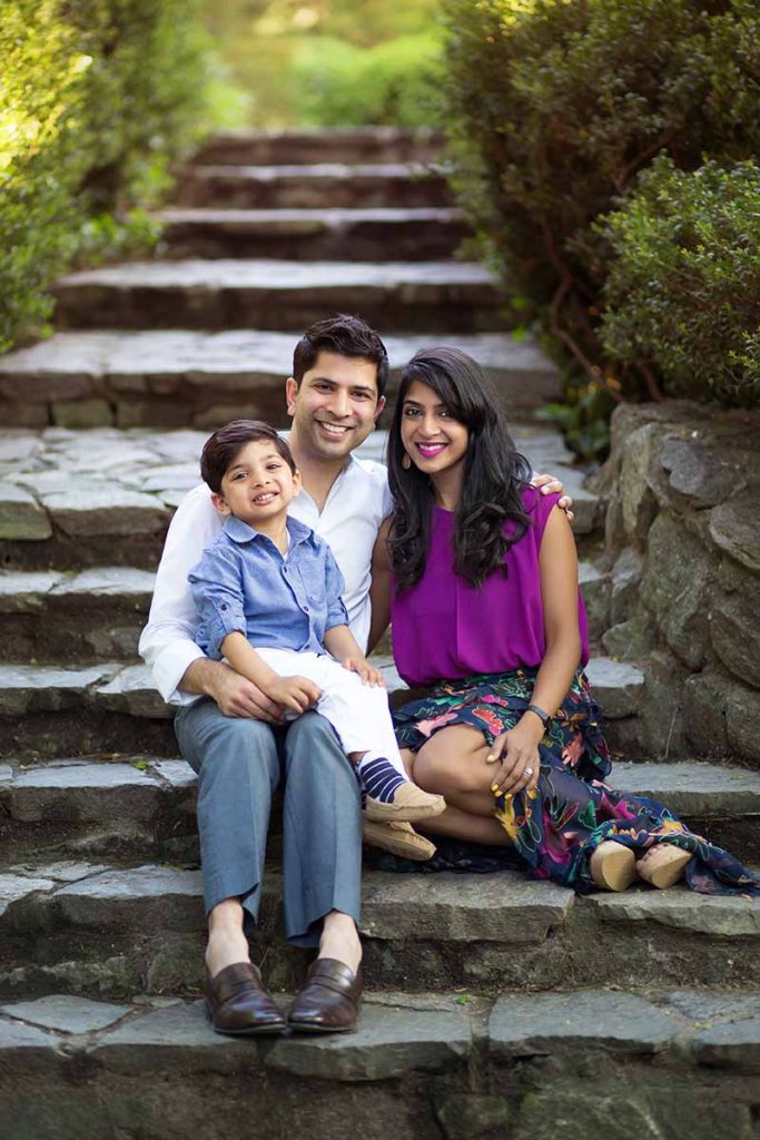 Family photo of a mother, father and their son on a beautiful stone path