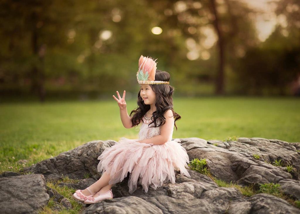 Girl in Tutu Du Monde and a headband playing in a park near Bronxville NY