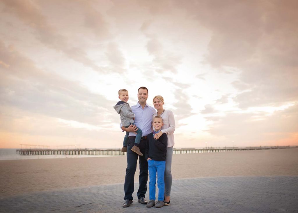 Beautiful family on the beach posing for a photo in Stamford CT