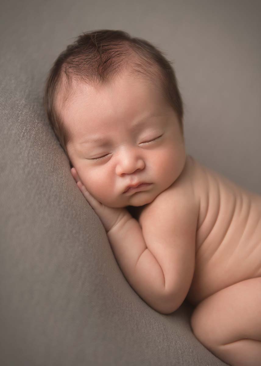 Portrait of an infant sleeping as taken at a newborn photography studio in Westchester county NY.