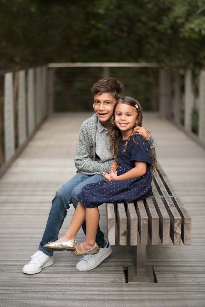 Modern park in Greenwich CT is the setting for this beautiful sibling portrait of a boy and a girl.
