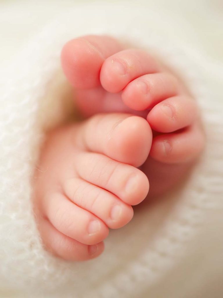 Artistic image showing a closeup of baby's toes