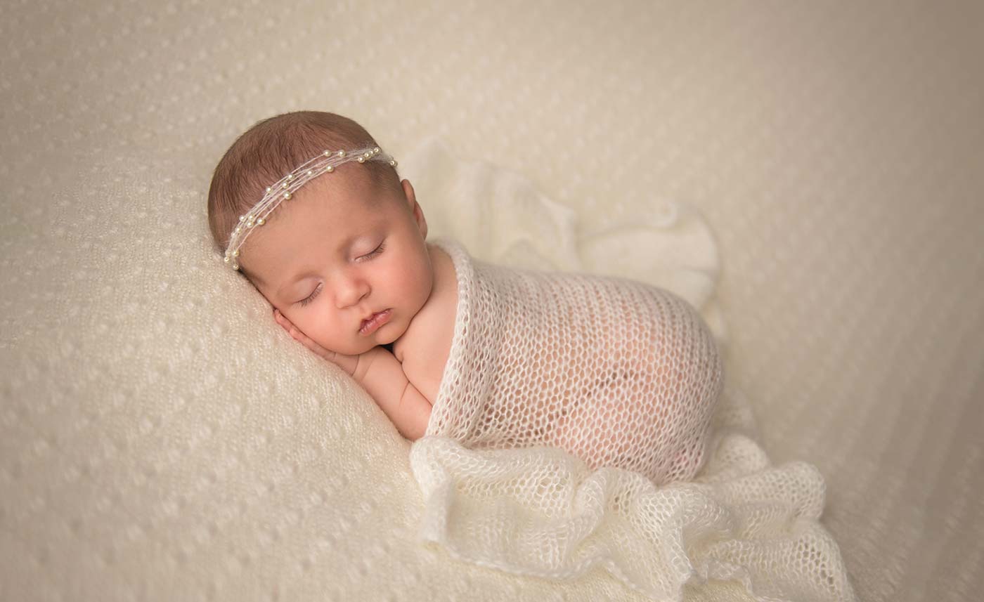 Newborn baby girl wearing a headband