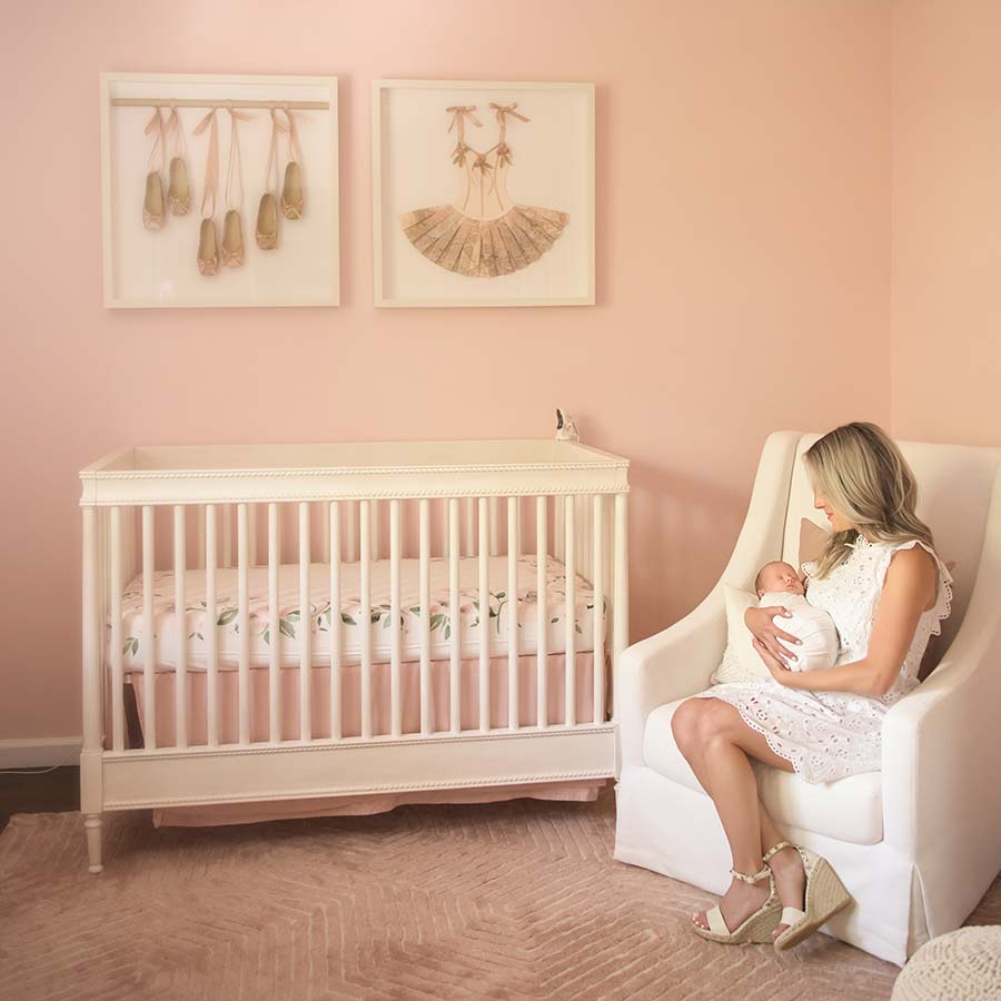 Mother holding her newborn baby at a modern Denver apartment