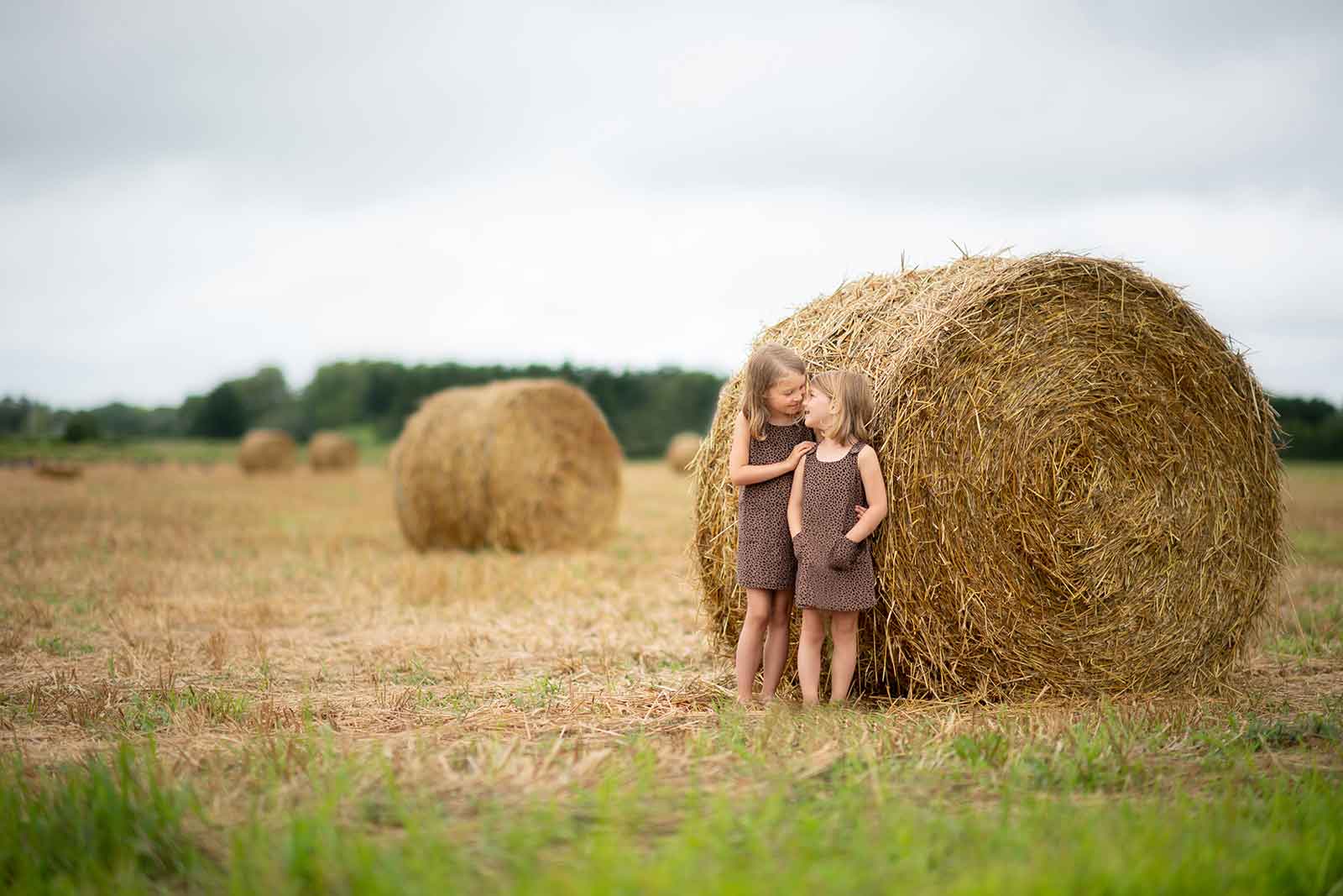 Two sisters share a laugh at a Denver farm in this lifestyle family photo